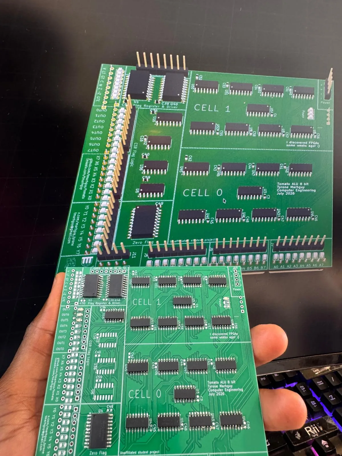 Half-soldered 07_alu board in hand, Digital simulation on the monitor behind it.